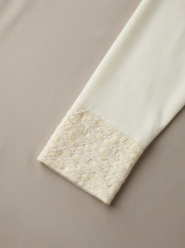 Close-up of a textured white tile with a beige border on a matching background